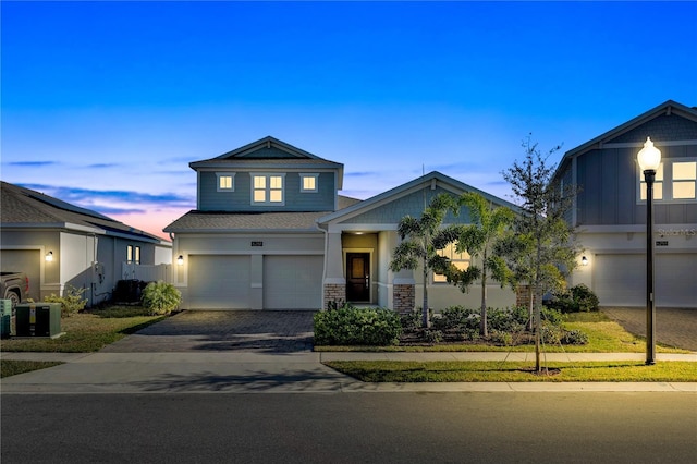 view of front facade featuring an attached garage and decorative driveway