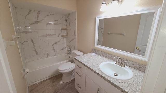 full bathroom featuring tiled shower / bath, vanity, and toilet