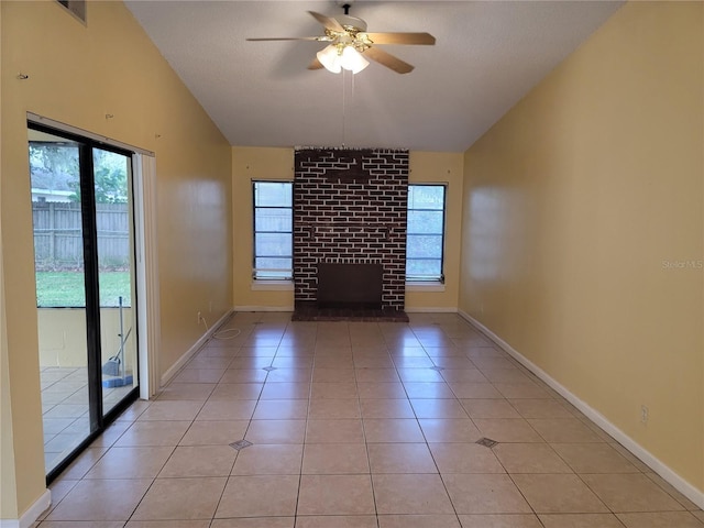 unfurnished living room featuring a fireplace, light tile patterned flooring, and ceiling fan