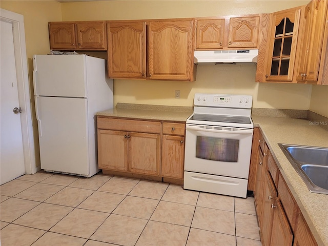 kitchen featuring sink, white appliances, and light tile patterned floors