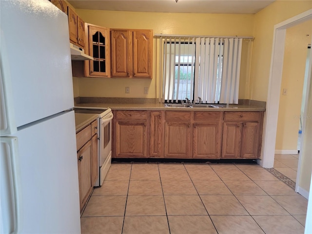 kitchen with sink, white appliances, and light tile patterned floors