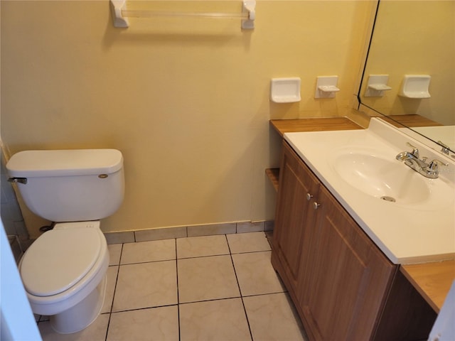 bathroom with toilet, tile patterned floors, and vanity