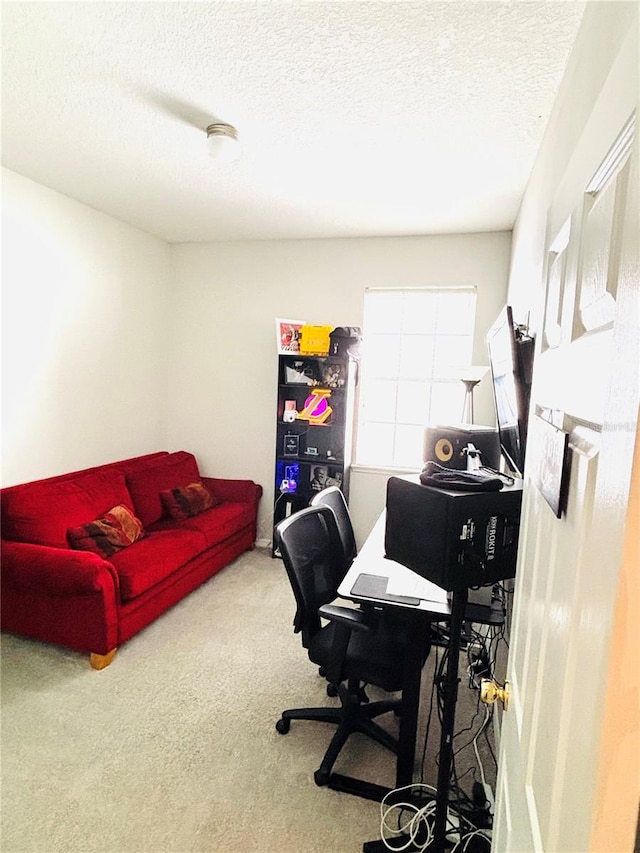 carpeted home office with a textured ceiling