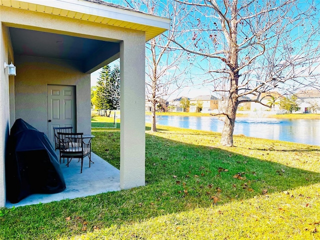 view of yard featuring a patio and a water view