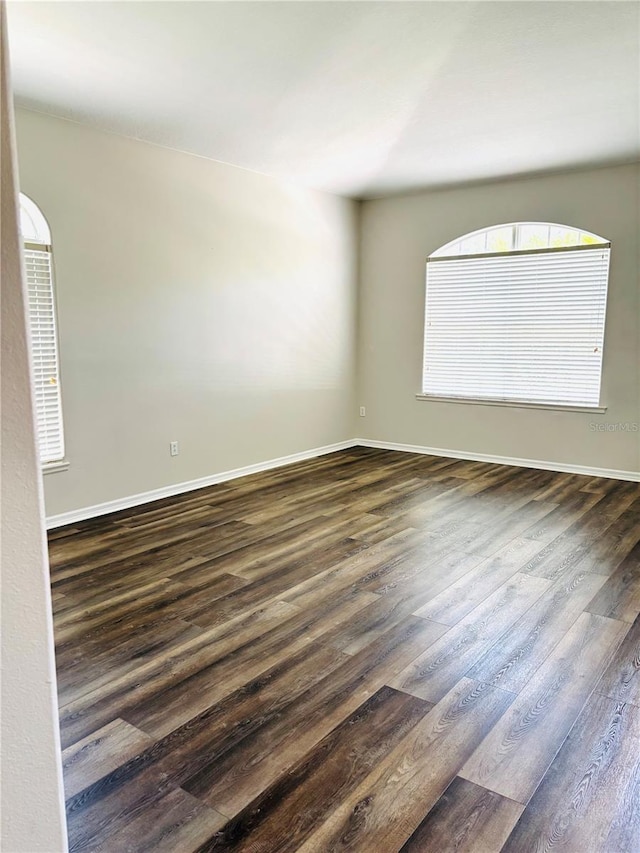 2304 Cedar Garden Dr, Orlando, FL 32824 - spare room featuring dark wood-type flooring and baseboards