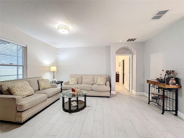 living room with a textured ceiling