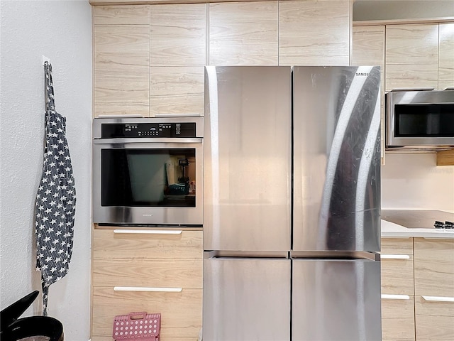 kitchen with stainless steel appliances and light brown cabinetry