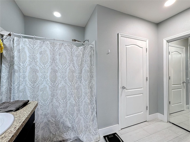 bathroom featuring tile patterned flooring and vanity