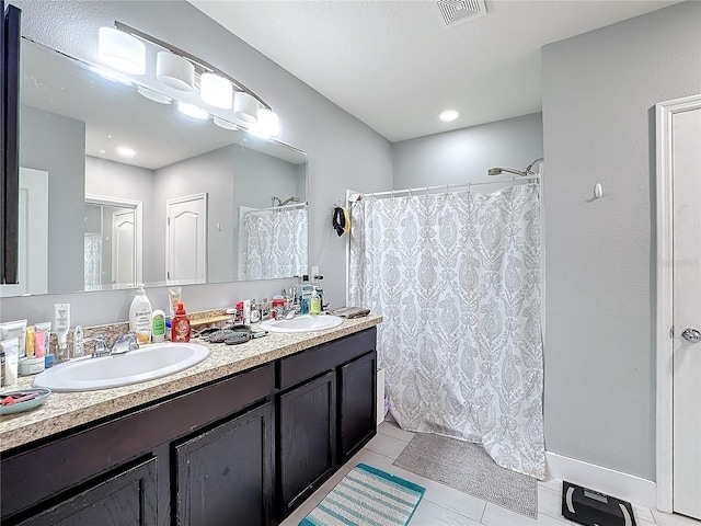 bathroom featuring tile patterned flooring, vanity, and a shower with shower curtain