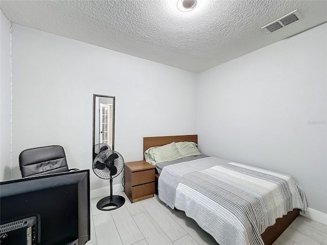 bedroom featuring a textured ceiling