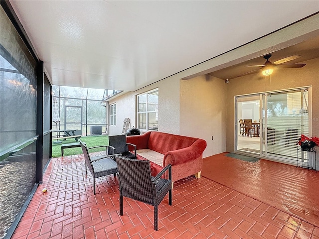 sunroom featuring cooling unit and ceiling fan