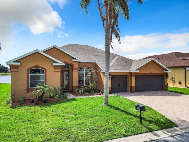 ranch-style home featuring a garage and a front lawn