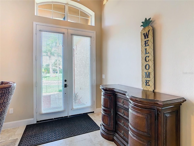 entryway with french doors and light tile patterned flooring