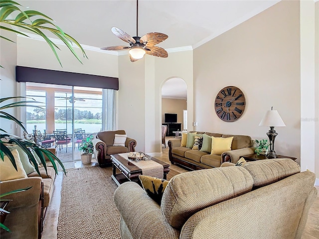 living room featuring crown molding, a water view, and ceiling fan