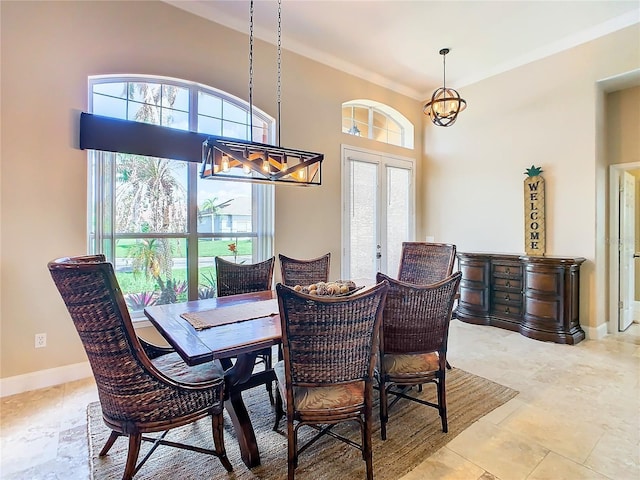 dining room featuring ornamental molding, french doors, and an inviting chandelier