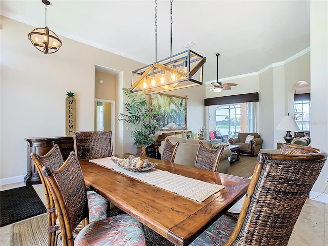 dining area with ceiling fan with notable chandelier, ornamental molding, and hardwood / wood-style floors