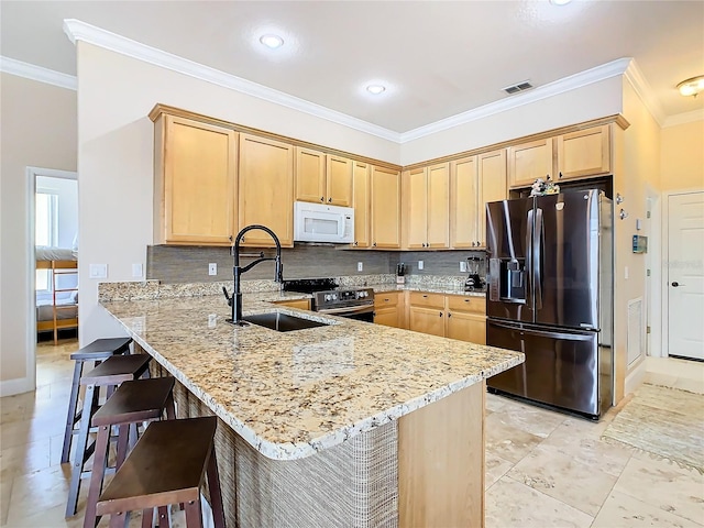 kitchen featuring kitchen peninsula, a kitchen breakfast bar, light stone countertops, and appliances with stainless steel finishes