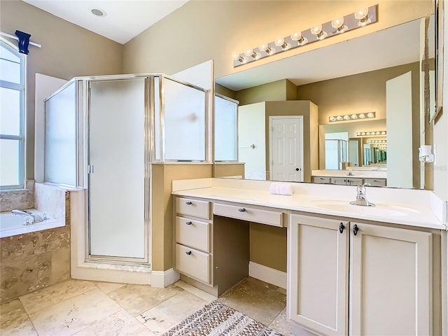 bathroom with vanity, a healthy amount of sunlight, and separate shower and tub