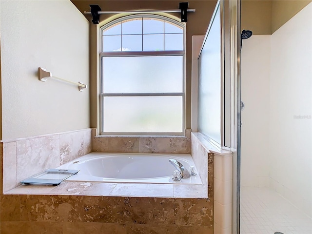 bathroom featuring separate shower and tub