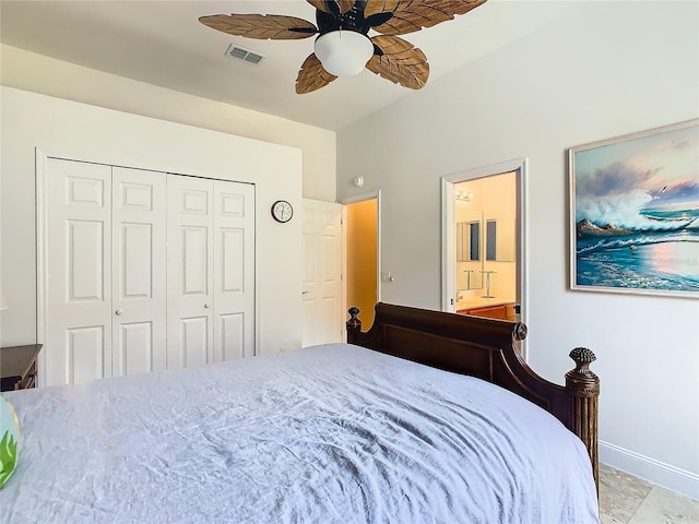 bedroom featuring a closet, ensuite bath, and ceiling fan