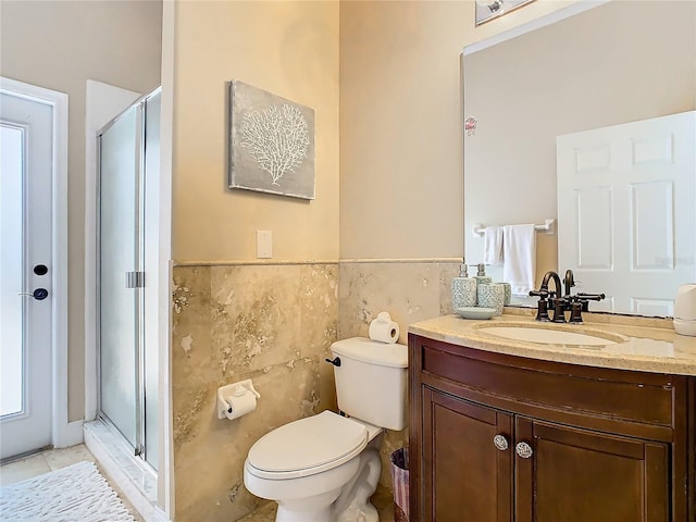 bathroom featuring tile patterned floors, tile walls, an enclosed shower, and vanity