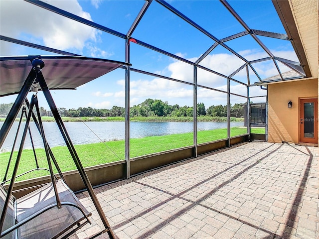 unfurnished sunroom with a water view