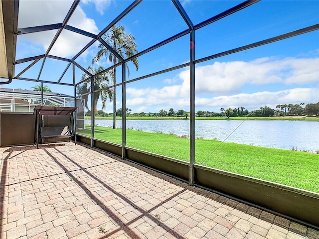 unfurnished sunroom featuring a water view