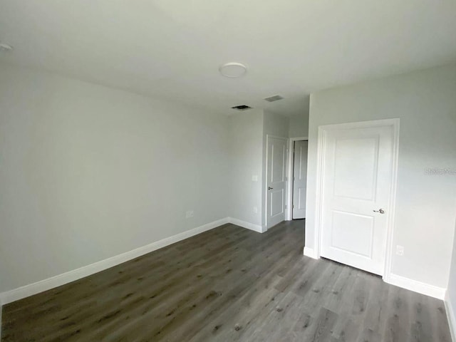 unfurnished room with hardwood / wood-style floors