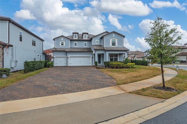 view of front of house featuring a garage and a front yard