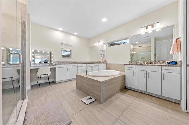 bathroom featuring vanity, shower with separate bathtub, and tile patterned flooring