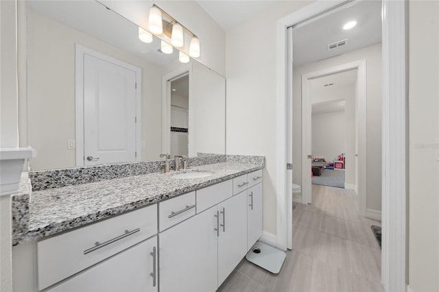 bathroom with toilet and vanity