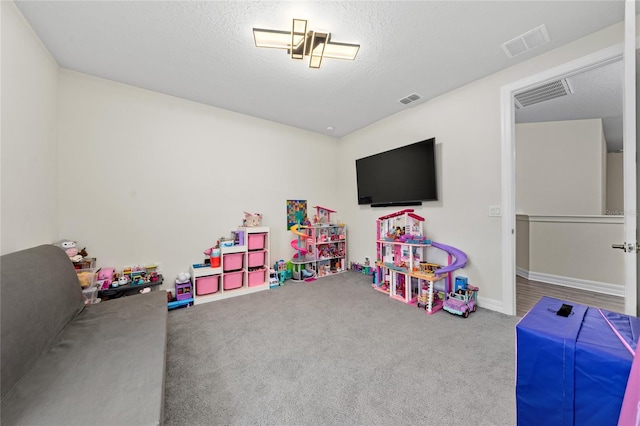 game room with carpet flooring and a textured ceiling