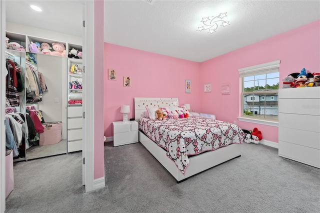 bedroom with carpet floors and a textured ceiling