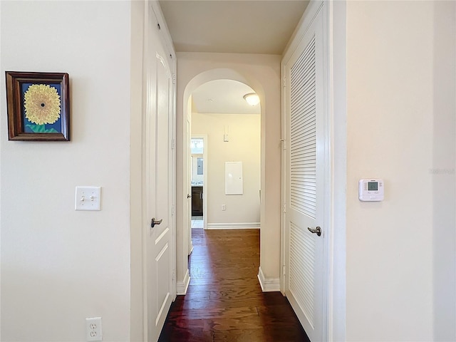 hall with dark hardwood / wood-style flooring