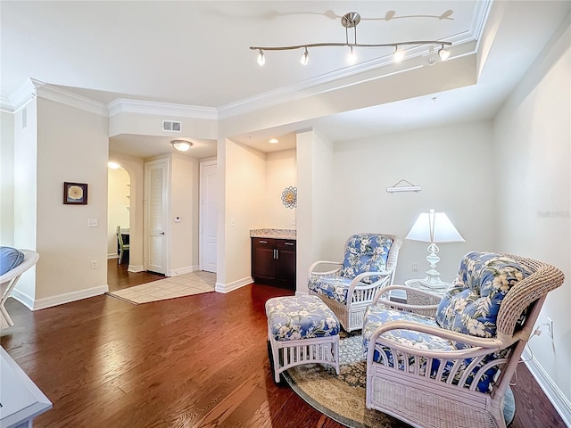 sitting room featuring crown molding and wood-type flooring