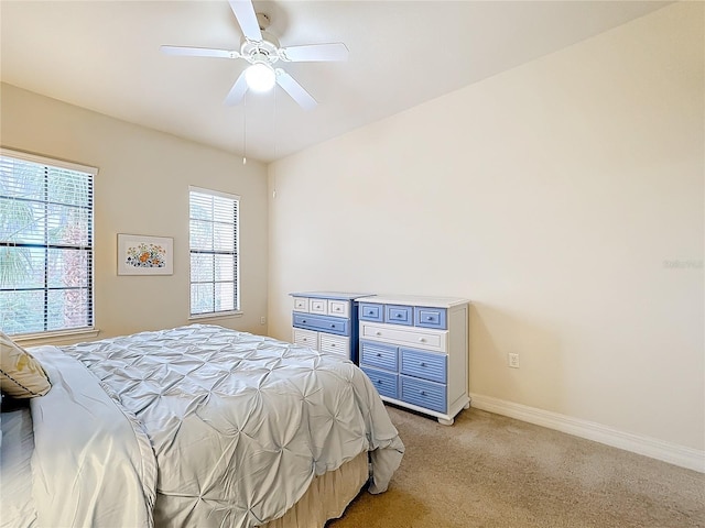 bedroom with ceiling fan and light carpet