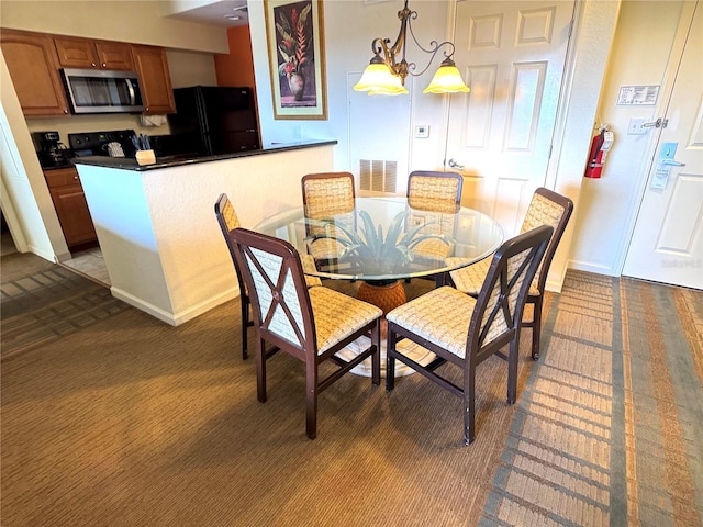 8100 Poinciana Blvd Unit 2703, Orlando, FL 32821 - carpeted dining area featuring a notable chandelier