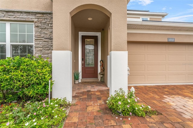 doorway to property with a garage