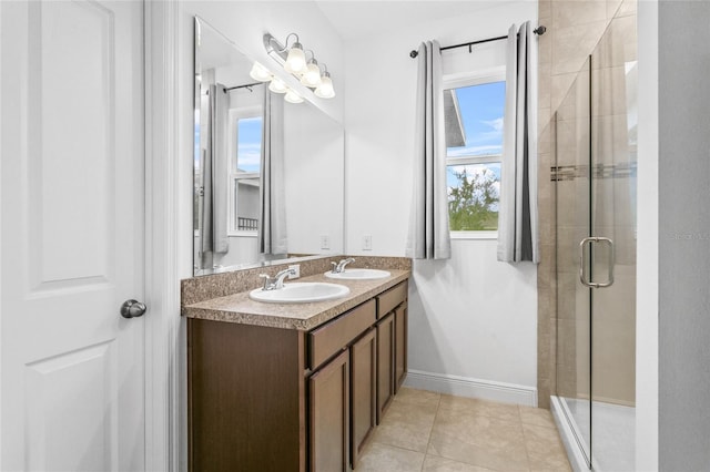 bathroom with tile patterned flooring, vanity, and a shower with door