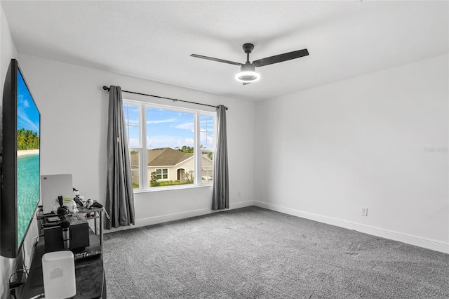 unfurnished room with carpet flooring and ceiling fan