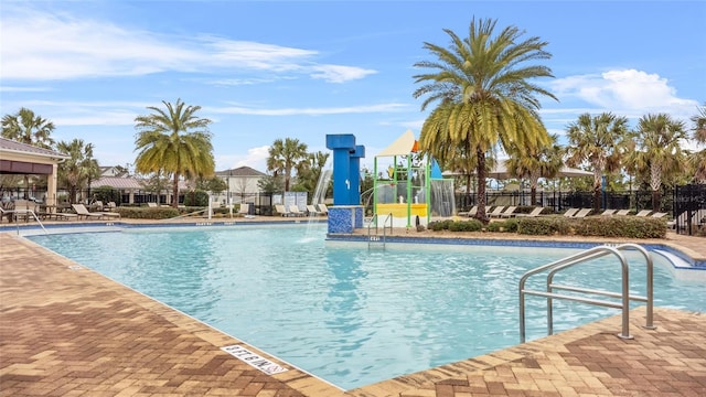 view of swimming pool with pool water feature