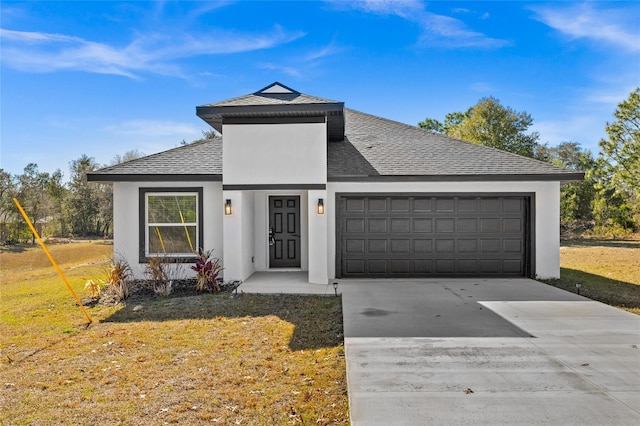 view of front of home with a garage and a front lawn