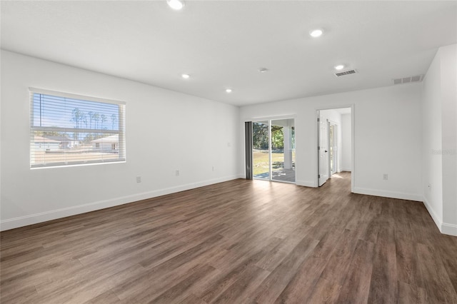 spare room with dark hardwood / wood-style flooring