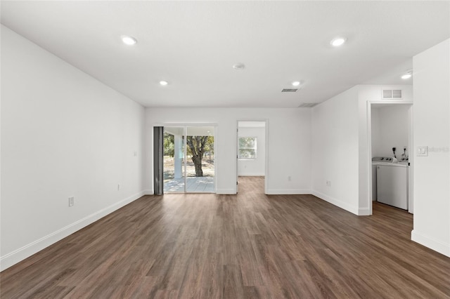 unfurnished room featuring dark hardwood / wood-style flooring and washer / dryer