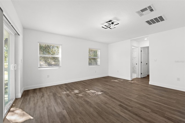 empty room with dark wood-type flooring