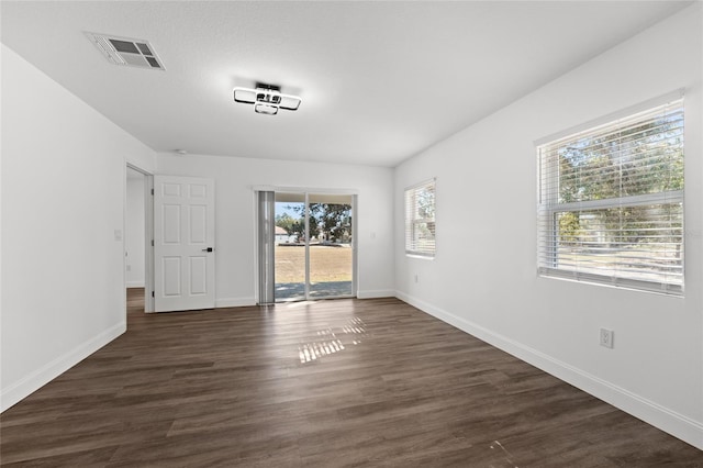 unfurnished room featuring dark hardwood / wood-style flooring