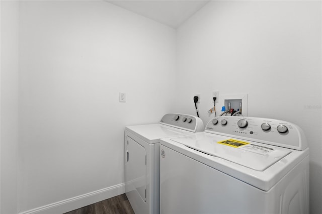 washroom featuring dark hardwood / wood-style flooring and washing machine and dryer