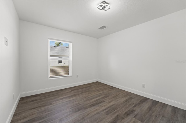 empty room featuring dark hardwood / wood-style floors