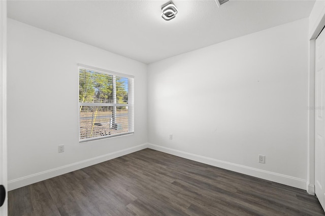 empty room featuring dark hardwood / wood-style floors