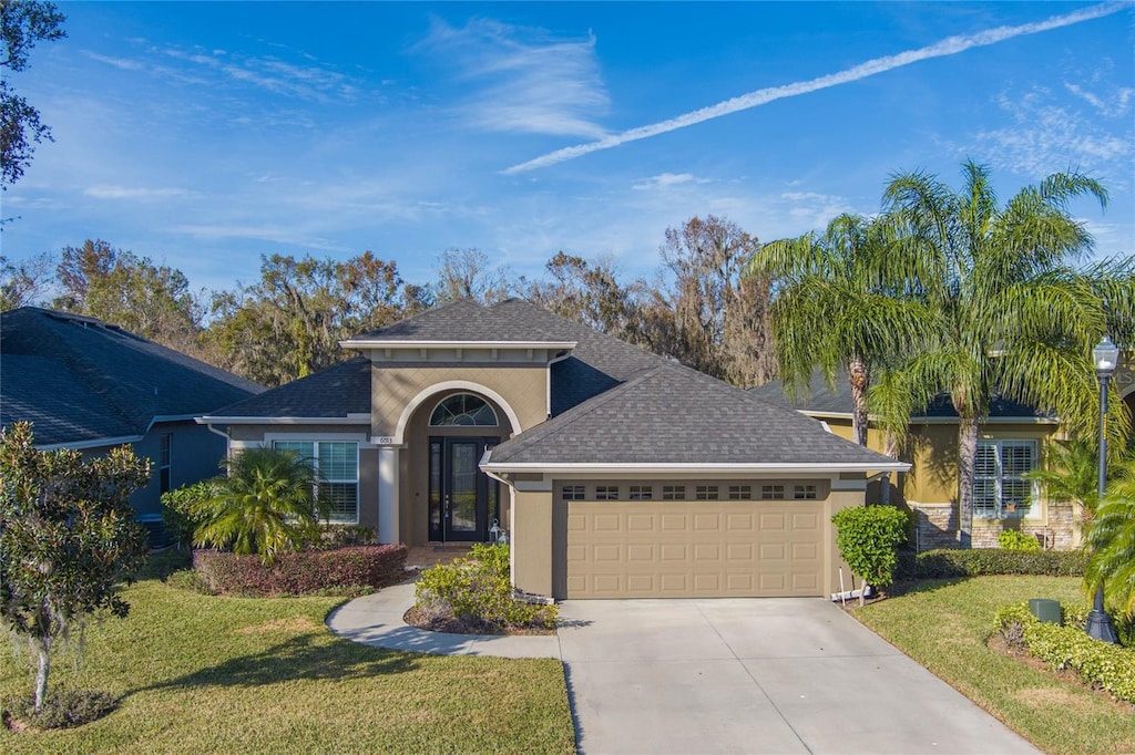 view of front of property featuring a garage and a front lawn